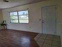 Bright room featuring laminate floors, and natural light from a large window at 1509 Overbrook Rd, Englewood, FL 34223