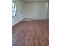 Spacious living room featuring laminate floors, neutral paint and natural light at 1509 Overbrook Rd, Englewood, FL 34223