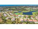 Beautiful aerial view of a neighborhood with mature landscaping, water features, and golf course at 16 Leeward Dr, Placida, FL 33946