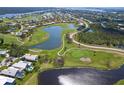 Stunning aerial view overlooking a lake and golf course in a quiet residential neighborhood at 16 Leeward Dr, Placida, FL 33946