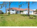 Charming single-story home with a tile roof, attached two-car garage, and lush front lawn at 16 Leeward Dr, Placida, FL 33946