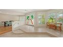 Open concept space with large windows, tile flooring, and a decorative stair railing at 1610 S Orange Ave, Sarasota, FL 34239