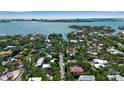 Stunning aerial view showcasing waterfront property in a serene location with beautiful blue water and lush greenery at 1677 Hyde Park St, Sarasota, FL 34239