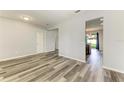 Bright living room with new floors, and access to other rooms, offering a seamless flow at 1721 Palm Warbler Ln, Ruskin, FL 33570