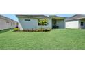 Lush backyard featuring healthy green grass and mature tropical landscaping at 17723 Palmiste Dr, Bradenton, FL 34202