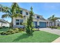 Stunning exterior of a new construction home with lush green lawn and landscaping at 17723 Palmiste Dr, Bradenton, FL 34202