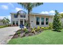 Beautifully landscaped front yard with a modern home and 'quick move-in' sign at 17911 Palmiste Dr, Bradenton, FL 34202