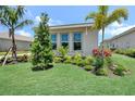 Close up of landscaping with decorative shrubs and a well maintained green lawn at 17911 Palmiste Dr, Bradenton, FL 34202