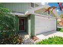 Close up of the front entrance, two car garage, and partial brick facade at 1869 Springbush Ln, Clearwater, FL 33763