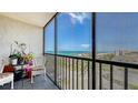 Relaxing screened balcony with seating area and panoramic ocean view at 2045 Gulf Of Mexico Dr # M1-514, Longboat Key, FL 34228