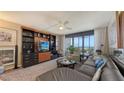 Inviting living room with built-in shelving and access to balcony at 2045 Gulf Of Mexico Dr # M1-514, Longboat Key, FL 34228