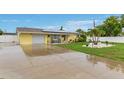 Well-maintained home with a spacious driveway, solar panels, and a lush, landscaped yard at 212 66Th Avenue W Dr, Bradenton, FL 34207