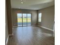 Bright and airy living area with sliding glass doors leading to the outside at 24831 Buckingham Way, Port Charlotte, FL 33980