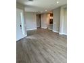 Spacious living room boasting modern wood-look tile flooring and neutral paint at 24831 Buckingham Way, Port Charlotte, FL 33980