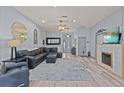 Spacious living room featuring a fireplace, ceiling fan, and modern decor at 318 39Th Ne St, Bradenton, FL 34208
