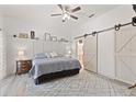 Comfortable main bedroom with barn door access to ensuite bathroom at 318 39Th Ne St, Bradenton, FL 34208