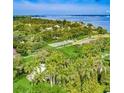 Beautiful aerial view of lush tropical landscaping near the open water at 3601 Riverview Blvd, Bradenton, FL 34205