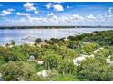 A picturesque aerial view of waterfront homes amongst tropical plants at 3601 Riverview Blvd, Bradenton, FL 34205