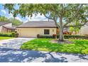 Inviting single-story home featuring a 1-car garage, lush landscaping, and a beautiful shade tree at 3914 Glen Oaks Manor Dr, Sarasota, FL 34232
