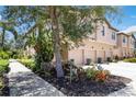 Charming townhome with lush landscaping, trees, and well-kept lawn at 4220 Via Piedra Cir # 4-101, Sarasota, FL 34233