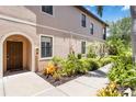 Inviting townhome entrance with well-manicured landscaping and a charming front door at 4220 Via Piedra Cir # 4-101, Sarasota, FL 34233