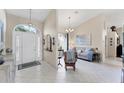Bright and airy living room showcasing high ceilings, tile floors, and a view to the front entrance at 4585 Dover Street E Cir, Bradenton, FL 34203