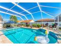 Inviting screened-in pool area with comfortable seating and a clear view of the blue sky above at 4585 Dover Street E Cir, Bradenton, FL 34203