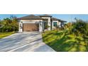 Inviting one-story home with a well-groomed lawn, a two-car garage, and elegant landscaping adding to its curb appeal at 5365 Craig Ter, Port Charlotte, FL 33981