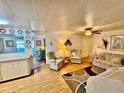 Cozy living room with comfortable seating, ceiling fan, and a seamless flow into other living areas at 5511 Denmark Dr, Bradenton, FL 34207