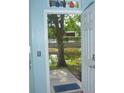 View from doorway to backyard featuring trees, pond, and fence at 5681 Bidwell Pkwy # 104, Sarasota, FL 34233
