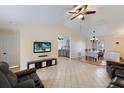Open-concept living room with tile flooring, high ceilings, and dining area view at 613 E 49Th E St, Bradenton, FL 34208
