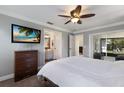 Comfortable main bedroom featuring an ensuite bathroom and access to a screened lanai at 613 E 49Th E St, Bradenton, FL 34208