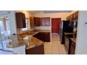A kitchen featuring granite countertops, stainless steel appliances and dark wood cabinets at 7004 Mauna Loa Blvd, Sarasota, FL 34241