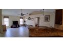 Open-concept layout with granite countertops, ceiling fan, and tile floors at 7004 Mauna Loa Blvd, Sarasota, FL 34241