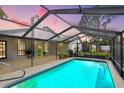 Inviting screened-in pool area perfect for relaxation and entertainment, surrounded by lush landscaping at 7321 Caladesia Dr, Sarasota, FL 34243