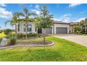 Charming home with manicured lawn, mature trees, and a spacious two-car garage at 7327 Summerland Cv, Bradenton, FL 34202