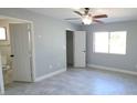 Spacious bedroom with tile flooring, a ceiling fan, and natural light at 7524 Kavanda St, North Port, FL 34287