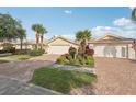 Charming home featuring a brick driveway, two-car garage, and a well-manicured lawn at 7632 Quinto Dr, Sarasota, FL 34238