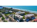 Aerial view of a condo community, showcasing beach access and carport parking at 8779 Midnight Pass Rd # 506H, Sarasota, FL 34242