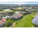 Scenic aerial view of the condominium complex overlooking a golf course and lake at 9630 Club South Cir # 6303, Sarasota, FL 34238