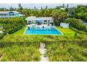 Charming home with a private pool and patio area, surrounded by well-manicured landscaping and a path to the beach at 102 77Th St, Holmes Beach, FL 34217