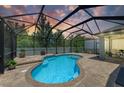 Beautiful kidney-shaped pool with a screened enclosure and brick paver patio at 11254 82Nd St E, Parrish, FL 34219