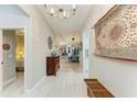Inviting hallway with wood-look tile, decorative wall hangings, and views into other living spaces at 12175 Maple Ridge Dr, Parrish, FL 34219