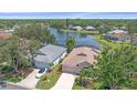 Aerial view of lakeside homes showcasing serene water views and a desirable neighborhood at 12322 Tall Pines Way, Lakewood Ranch, FL 34202