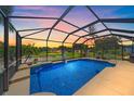 Sparkling screened-in pool offers stunning water views and lounge area for relaxation and outdoor enjoyment at 12322 Tall Pines Way, Lakewood Ranch, FL 34202