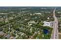 A beautiful aerial view of the neighborhood, showcasing homes and the nearby highway at 135 Tall Trees Ct, Sarasota, FL 34232