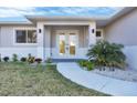 Close up of front door with manicured landscaping and hardscaped walkway at 14065 Paris Ln, Port Charlotte, FL 33981