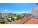 Relax on the balcony and enjoy views of lush grounds, a pool, and the azure ocean at 1465 Gulf Of Mexico Dr # 502, Longboat Key, FL 34228