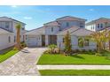Beautiful two-story home featuring a one-car garage, stone accents, and professionally landscaped yard at 17122 Ranchside Pl, Bradenton, FL 34211