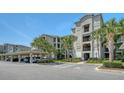 Three story condominium building with covered parking, handicap access, and mature landscaping at 17704 Gawthrop Dr # 303, Lakewood Ranch, FL 34211
